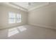 Spacious bedroom with tray ceiling, neutral carpet and plentiful natural light at 200 Rivermere Way, Sandy Springs, GA 30350