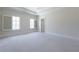 A spacious bedroom with carpeted floors, plantation shutters, and a private entrance at 200 Rivermere Way, Sandy Springs, GA 30350