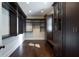 A spacious walk-in closet with custom shelving and dark wood floors at 200 Rivermere Way, Sandy Springs, GA 30350