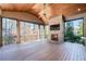 Relaxing screened-in patio featuring a brick fireplace, ceiling fan, and exterior views at 200 Rivermere Way, Sandy Springs, GA 30350