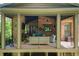 Screened-in patio features an outdoor seating area, a TV, and wood-burning fireplace at 200 Rivermere Way, Sandy Springs, GA 30350