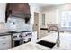 The gourmet kitchen features stainless steel appliances, a pot filler, and custom countertops at 200 Rivermere Way, Sandy Springs, GA 30350