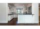 Gourmet kitchen area with white cabinets, bar seating, and stone countertops at 200 Rivermere Way, Sandy Springs, GA 30350