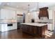 The spacious gourmet kitchen is equipped with stainless steel appliances, custom cabinets, and a large center island at 200 Rivermere Way, Sandy Springs, GA 30350