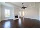Bright living room with a fireplace, dark hardwood floors, and a modern ceiling fan at 200 Rivermere Way, Sandy Springs, GA 30350