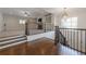 A versatile loft area with stairs, railing, and a view of the living area at 200 Rivermere Way, Sandy Springs, GA 30350