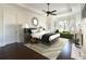 Comfortable main bedroom with a ceiling fan, bay window, and fireplace at 200 Rivermere Way, Sandy Springs, GA 30350