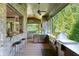 Covered outdoor kitchen area with stainless steel appliances, a bar, and seating at 200 Rivermere Way, Sandy Springs, GA 30350