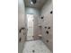 A modern walk-in shower features elegant fixtures, a tiled floor, and recessed shelving at 200 Rivermere Way, Sandy Springs, GA 30350
