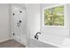 Modern bathroom with glass shower, tub, and bright window offering a clean, fresh space at 2949 Jefferson St, Austell, GA 30106