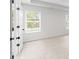 Bright bedroom with carpet and view from doorway of the yard through the windows with blinds at 2949 Jefferson St, Austell, GA 30106