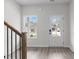 Bright foyer featuring wood-look flooring, a staircase, and a front door with glass panels at 2949 Jefferson St, Austell, GA 30106