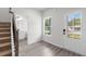 Bright foyer featuring wood-look flooring, a staircase, and a front door with glass panels at 2949 Jefferson St, Austell, GA 30106