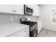 Close up of a modern kitchen featuring stainless steel appliances and white quartz countertops at 2949 Jefferson St, Austell, GA 30106