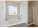 Bright bathroom features a soaking tub with a window and a separate glass-enclosed shower at 3243 Shoals Park Dr, Decatur, GA 30034