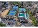 Aerial view of tennis courts, pool, and clubhouse amenities in a well-maintained community setting at 525 Water Shadow Ln, Alpharetta, GA 30022