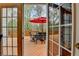 Open back deck view from inside the house with outdoor furniture and an umbrella at 525 Water Shadow Ln, Alpharetta, GA 30022