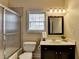 Bathroom featuring a shower with glass door, toilet, and vanity with white countertop and mirror at 525 Water Shadow Ln, Alpharetta, GA 30022