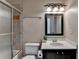 Bathroom featuring a glass-enclosed shower, toilet, and a vanity with a black frame mirror at 525 Water Shadow Ln, Alpharetta, GA 30022