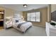 Bright bedroom with a large window, plush carpet, and an en-suite bathroom at 525 Water Shadow Ln, Alpharetta, GA 30022