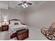 Bedroom with a rocking chair, side table with a lamp, and a woven storage ottoman at 525 Water Shadow Ln, Alpharetta, GA 30022