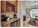 Elegant coffee bar area with granite countertop and custom wine rack at 525 Water Shadow Ln, Alpharetta, GA 30022