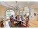 Formal dining room with stylish furniture, a decorative rug, and views of the open-concept living space at 525 Water Shadow Ln, Alpharetta, GA 30022