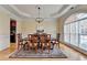 Elegant dining room with a large window, decorative rug, and a classic chandelier for a warm ambiance at 525 Water Shadow Ln, Alpharetta, GA 30022