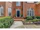 Charming brick home featuring a well-maintained front yard and a welcoming entrance with decorative plants at 525 Water Shadow Ln, Alpharetta, GA 30022