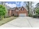 Traditional brick home featuring a well-manicured lawn and long driveway at 525 Water Shadow Ln, Alpharetta, GA 30022