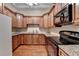 Well-lit kitchen with stainless steel appliances, wood cabinets, granite countertops, and hardwood floors at 525 Water Shadow Ln, Alpharetta, GA 30022