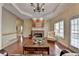 Spacious living room with a brick fireplace, hardwood floors, and ample seating at 525 Water Shadow Ln, Alpharetta, GA 30022