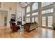 Spacious living room featuring large windows, a fireplace, and comfortable seating in a well-lit setting at 525 Water Shadow Ln, Alpharetta, GA 30022