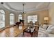 Cozy living room with hardwood floors, piano, and ample seating at 525 Water Shadow Ln, Alpharetta, GA 30022