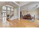 Open-concept living space with grand windows, staircase, hardwood floors, and dining area at 525 Water Shadow Ln, Alpharetta, GA 30022