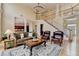 Open-concept living space with a staircase, comfortable seating, and views of the dining and kitchen areas at 525 Water Shadow Ln, Alpharetta, GA 30022