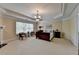 Spacious main bedroom featuring neutral walls, carpeted floor, and large window for natural light at 525 Water Shadow Ln, Alpharetta, GA 30022