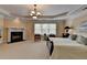 Main bedroom with sitting area, fireplace, and large windows offering lots of natural light at 525 Water Shadow Ln, Alpharetta, GA 30022