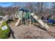 Community playground with slide, climbing structure, and park benches surrounded by mature trees at 525 Water Shadow Ln, Alpharetta, GA 30022