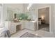 Large bathroom with a double vanity, large mirrors, and neutral color palette at 760 Valley Summit Drive, Roswell, GA 30075