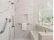 Bathroom showing large marble walk-in shower with built in bench and accessible grab bars at 760 Valley Summit Drive, Roswell, GA 30075