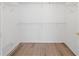 Walk-in closet featuring wood laminate flooring and wire shelving at 760 Valley Summit Drive, Roswell, GA 30075