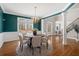Formal dining room featuring elegant chandelier, crown molding, and large windows at 760 Valley Summit Drive, Roswell, GA 30075