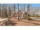 Charming two-story brick home with a well-manicured lawn and mature trees, set back from the street at 760 Valley Summit Drive, Roswell, GA 30075