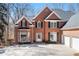 Elegant brick home featuring a two-car garage, a well-manicured lawn, and a welcoming entrance at 760 Valley Summit Drive, Roswell, GA 30075