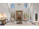Sun-drenched living room with a stone fireplace and soaring windows to let the outdoors in at 760 Valley Summit Drive, Roswell, GA 30075