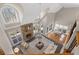 Open living room featuring a stone fireplace, soaring ceilings, and a cozy seating area at 760 Valley Summit Drive, Roswell, GA 30075