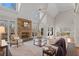 Bright living room with stone fireplace, hardwood floors, and expansive windows offering stunning views at 760 Valley Summit Drive, Roswell, GA 30075
