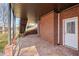 Covered outdoor patio with brick columns, brick walls, and a stone tile floor at 760 Valley Summit Drive, Roswell, GA 30075
