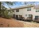 Exterior view of townhomes showing decks/patios and sloped backyards with small trees at 1536 Liberty Nw Pkwy, Atlanta, GA 30318
